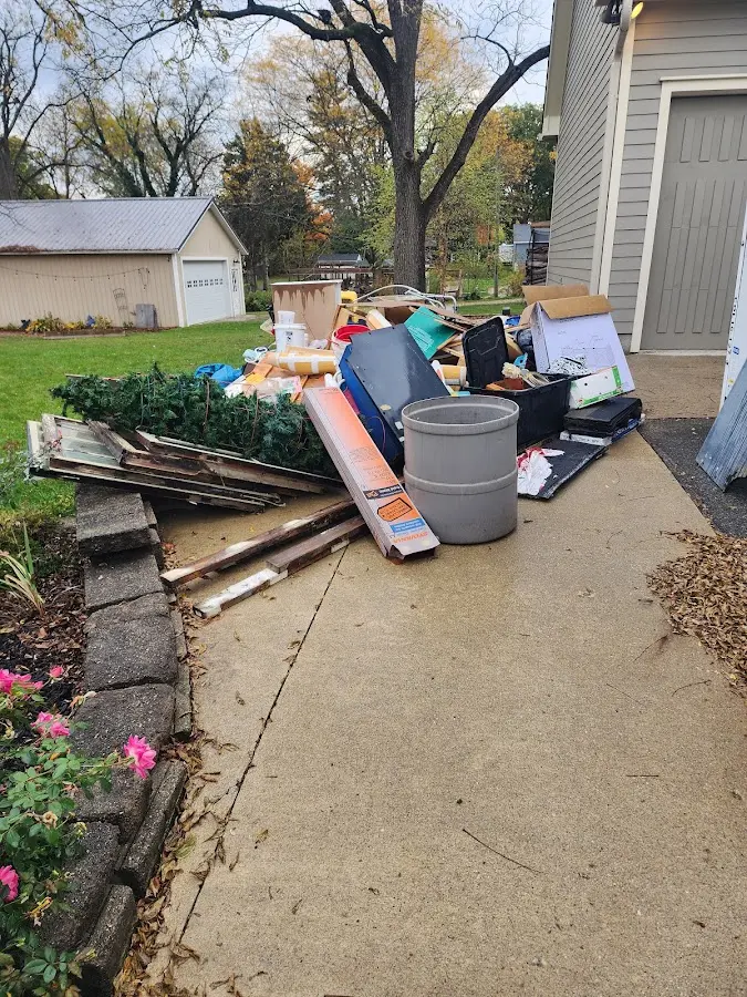 Dumpster being loaded with debris for 3 Yard Dumpster Rental in Saylorville